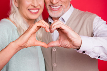 Wall Mural - Cropped close up photo beautiful she her he him his aged guy lady partners couple making heart figure fingers romance date anniversary wear sweater shirt waistcoat isolated red burgundy background