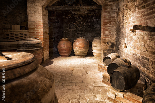 Old Wooden barrels with wine in a wine vault Canvas Print