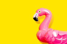 Creative Summer Beach Concept. Inflatable Pink Mini Flamingo On Yellow Background, Pool Float Party. Flat Lay, Copy Space. Flamingo Trend Inflatable Toy. Summer Background. Layout For Design