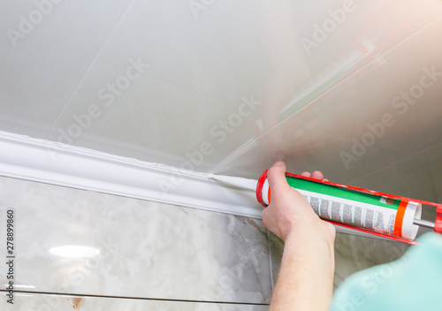 Man Is Putting Gypsum Baseboard With Glue On Ceiling