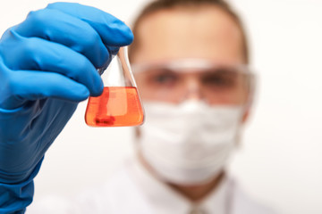 Scientist holding small test tube with experimental liquid