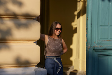 Wall Mural - Outdoor portrait of a young smiling woman on the street 