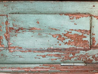 Old wooden door with shabby turquoise paint