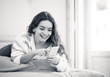 © SB Arts Media - Portrait of young beautiful girl texting and chatting on her sma