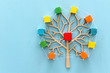 © tomertu - Business image of wooden tree with colorful cubes over blue table, human resources and management concept