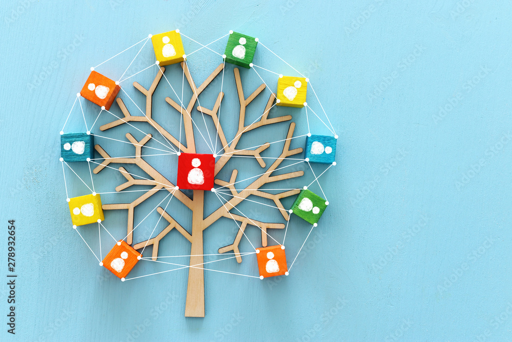 Business image of wooden tree with people icons over blue table, human resources and management concept - obrazy, fototapety, plakaty 