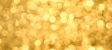 Golden Yellow Background With Abstract Blurred Highlights. Bokeh In Blur.