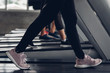 © ic36006 - Close up shoe and legs. Asian women running in a gym on a treadmill.