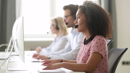 Wall Mural - african female call center agent using computer consulting customer