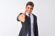 © Krakenimages.com - Young handsome businessman wearing suit standing over isolated white background smiling friendly offering handshake as greeting and welcoming. Successful business.