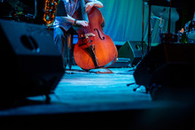 Artist Playing Double Bass Live On Stage During Music Event