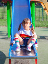 Cute Beautiful Smiling Little Girl On A Playground