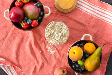 Wall Mural - Raw Cereals with mix fruits plate on a light background top view