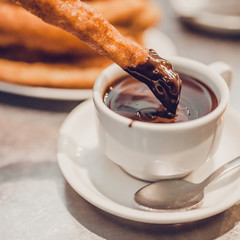 The Spaniards decided to dip churros in a cup of hot chocolate