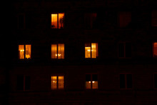 Illuminated In The Dark Of The Night The Windows Of The Houses Of An Apartment House