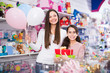 © JackF - cheerful woman and daughter with gifts and balloons in the shop