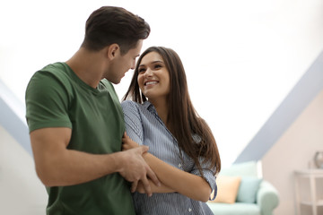 Wall Mural - Beautiful young couple dancing indoors