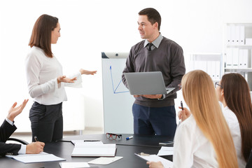 Wall Mural - Group of people with business trainer at management seminar