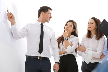 Wall Mural - Group of people with business trainer at management seminar