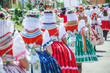 Young women during parade in traditional Czech folklore costumes. Photographed in Southern Moravia, Czechia. Moravian motifs. Festive, tradition