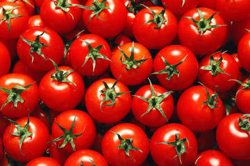 Delicious ripe cherry tomatoes as background, top view