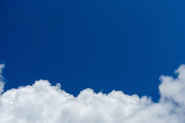 white cumulus clouds against blue sky. place for text.