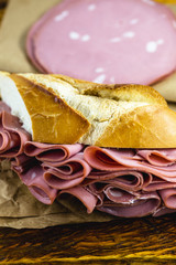 Wall Mural - Traditional mortadella sandwich. Salt bread with bologna. Great snack of pork with bread, typical of Brazil.