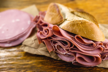 Wall Mural - bread with mortadella typical of Brazil. Bakery snack. Snack made at the municipal market of the city of São Paulo.