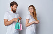 © SHOTPRIME STUDIO - happy couple with shopping bags isolated on white