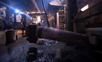 Wall Mural - old mechanical hammer at blacksmith traditional workshop