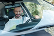 © LIGHTFIELD STUDIOS - selective focus of happy man driving car and looking at map
