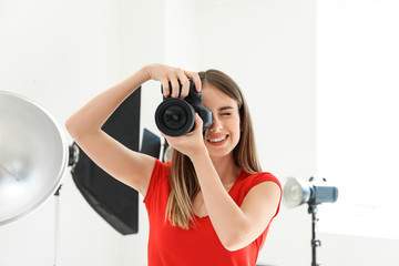 Wall Mural - Young female photographer in studio