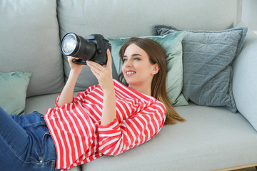 Wall Mural - Young female photographer at home