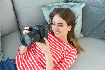 Wall Mural - Young female photographer at home