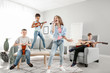 © Pixel-Shot - Teenage musicians playing and singing at home