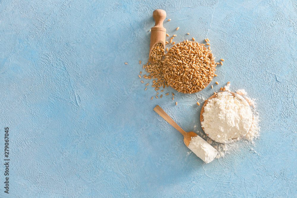 Wheat flour with grains on color background