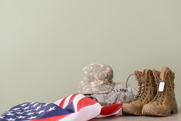 Military uniform and USA flag on table