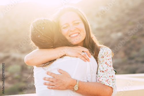 Fotomural Love and friendship concept twith couple of women young friends hugging and smil