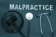 Wooden judge gavel and stethoscope on table, malpractice concept