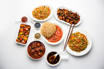 Assorted Indo chinese dishes in group includes Schezwan/Szechuan hakka noodles, veg fried rice, veg manchurian, american chop suey, chilli paneer, crispy vegetable and vegetable soup