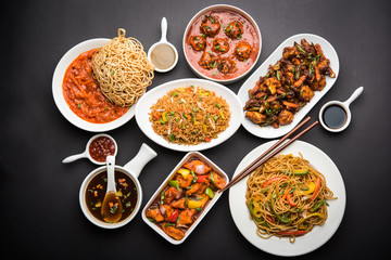 Assorted Indo chinese dishes in group includes Schezwan/Szechuan hakka noodles, veg fried rice, veg manchurian, american chop suey, chilli paneer, crispy vegetable and vegetable soup