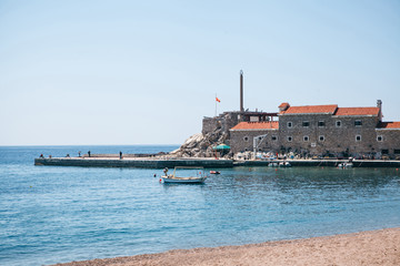 Wall Mural - Beautiful view of the ancient or old fort near the coast in Petrovac in Montenegro. Town Landmark.