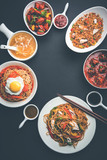 Fototapeta  - Assorted Indo chinese food in group includes non vegetarian or chicken Schezwan/Szechuan hakka noodles, fried rice, manchurian, egg american chop suey, soup with spoon and chop sticks, selective focus