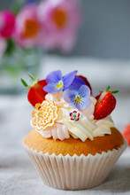 Cupcake Decorated With Buttercream, Fruits And Flowers