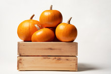 Ripe Orange Pumpkins In A Wooden Box