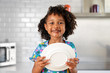 © Lisa Tichané - Portrait of young girl with messy chocolate face holding plate
