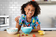 © Lisa Tichané - Smiling girl eating strawberries with whipped cream on her nose