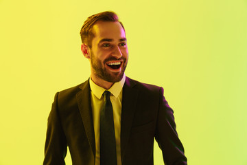 Poster - Image of excited young businessman in formal suit smiling and rejoicing