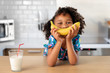 © Lisa Tichané - Playful girl smiling with banana over her mouth