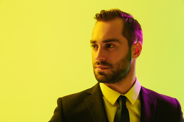 Poster - Image of serious young businessman in formal suit posing at camera